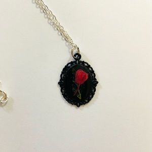 Tiny single red flower in black bezel and resin
